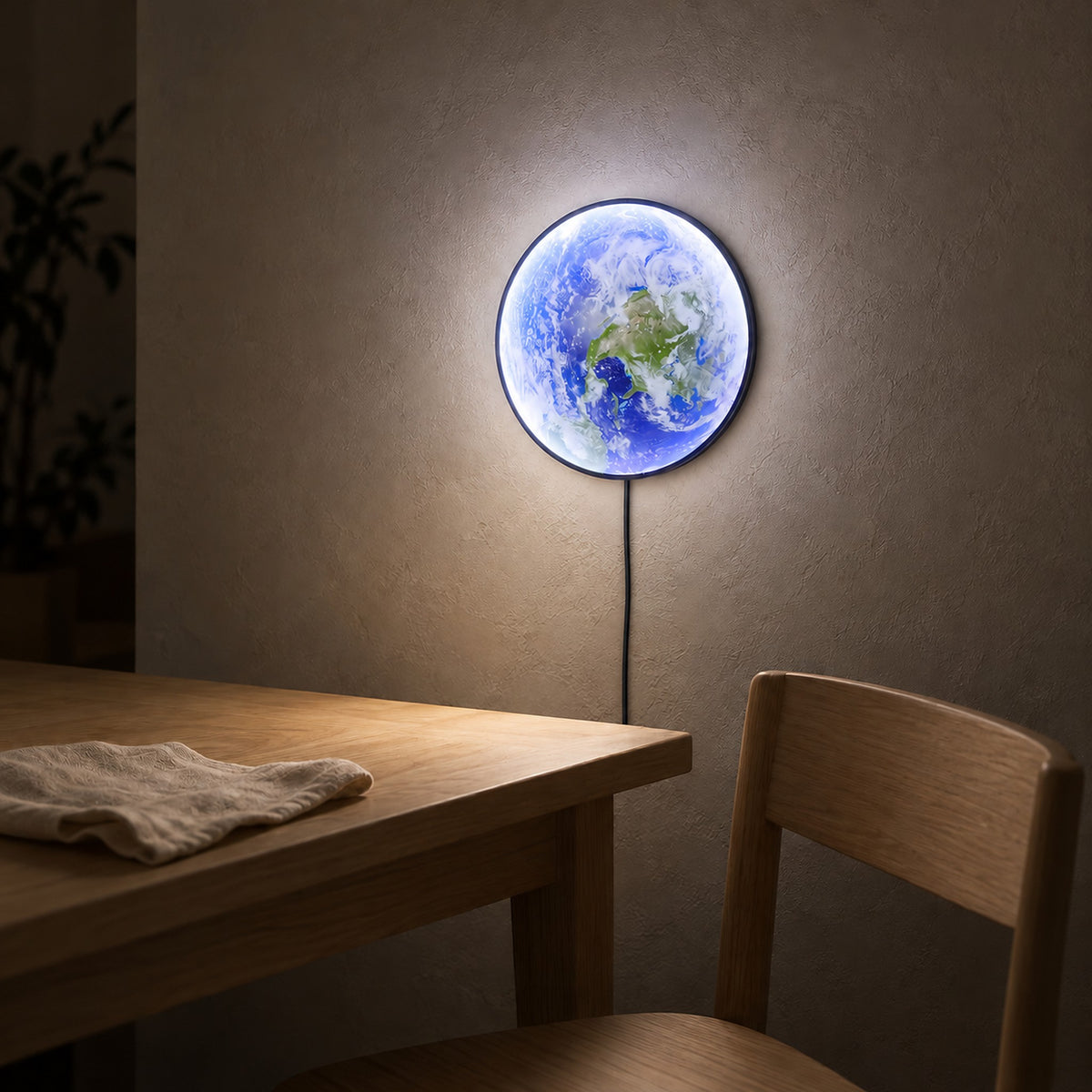 Tolanvi earth wall light in blue earth and dark rim, an LED wall sconce glowing above a dining table after dark
