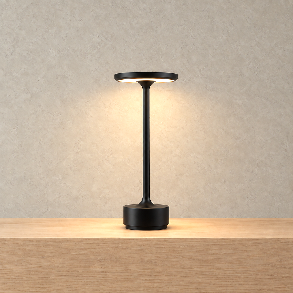 Tolimera black LED desk lamp with its underside ring glowing warm white