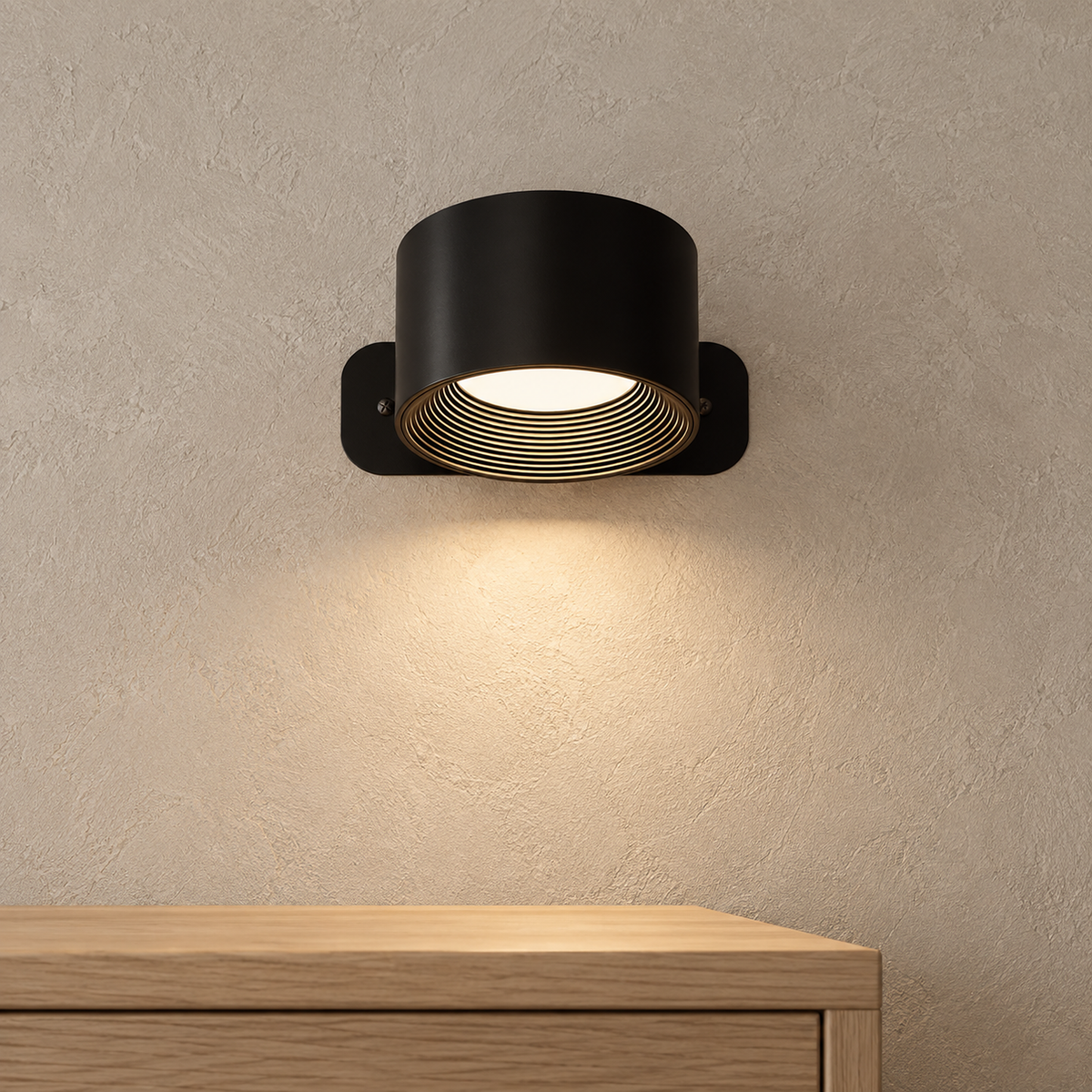Tomelira black rechargeable wall sconce casting a warm pool above a sideboard corner in late afternoon