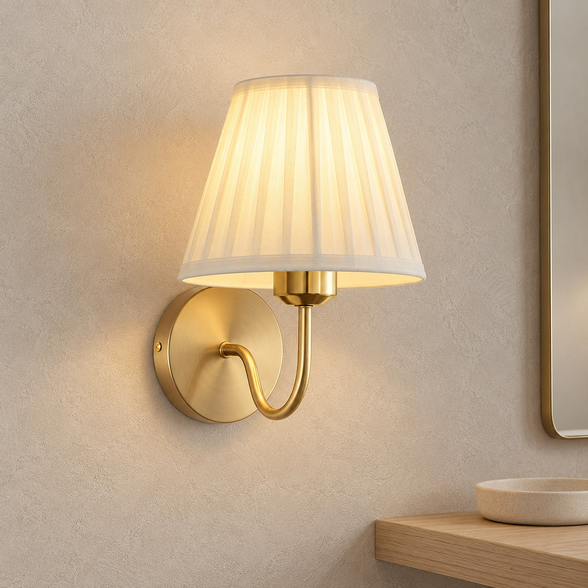 Tomirel gold cordless wall lamp glowing beside a dressing mirror in a bright dressing room