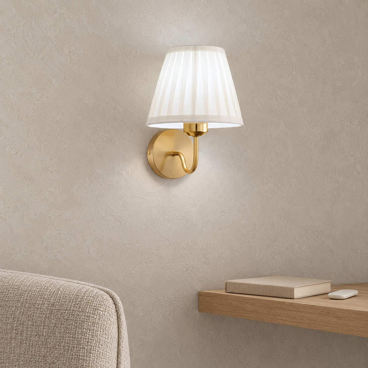 Tomirel gold wireless wall light glowing cool white beside a reading chair in daylight