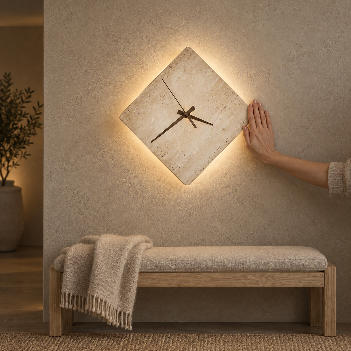 Toselmi yellow travertine LED wall sconce in the large 30 cm size lit beside a hand above an upholstered bench