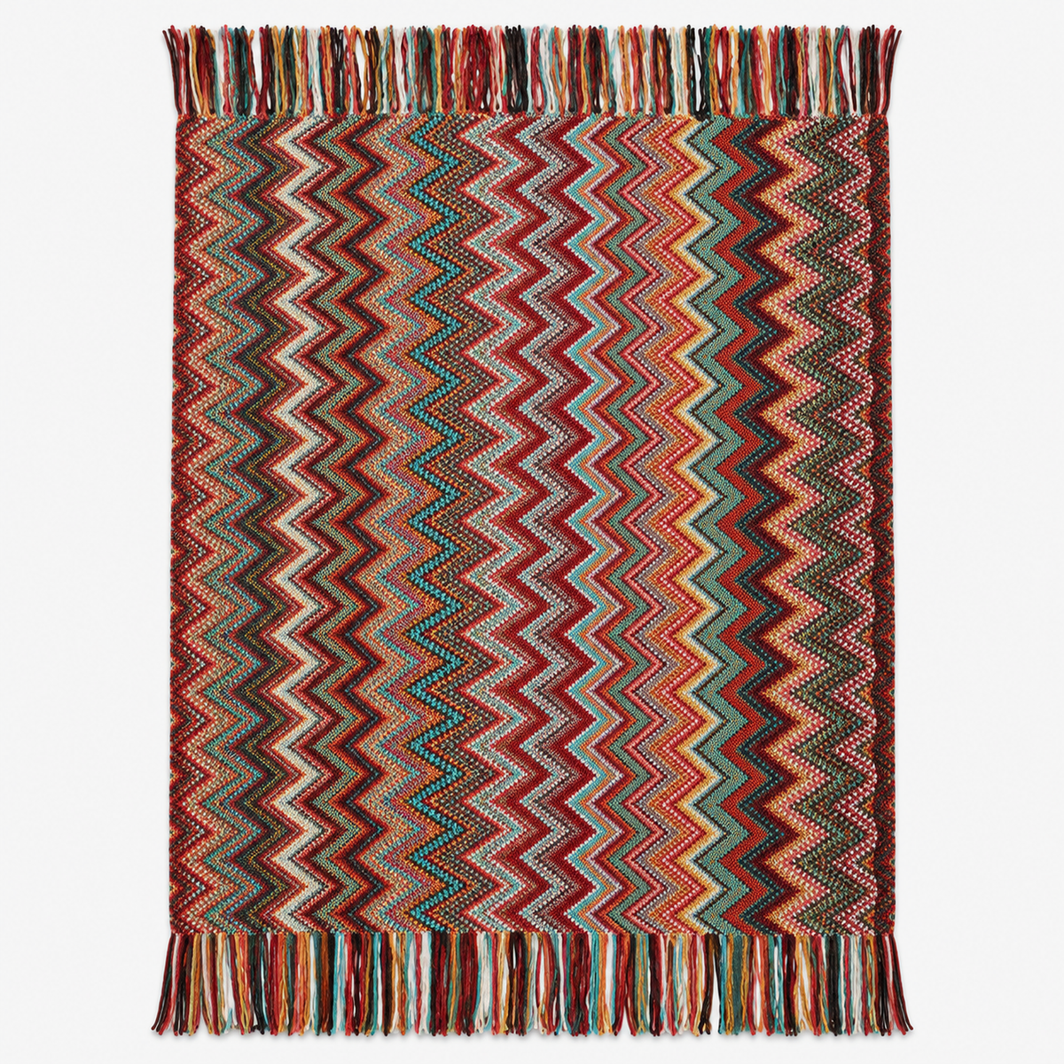 Vanolira knit throw blanket in red, laid open to show the multicolored zigzag pattern and tasseled ends