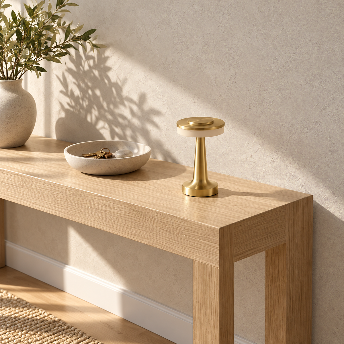 Vanolire gold battery operated table lamp resting unlit on a sunlit entryway console