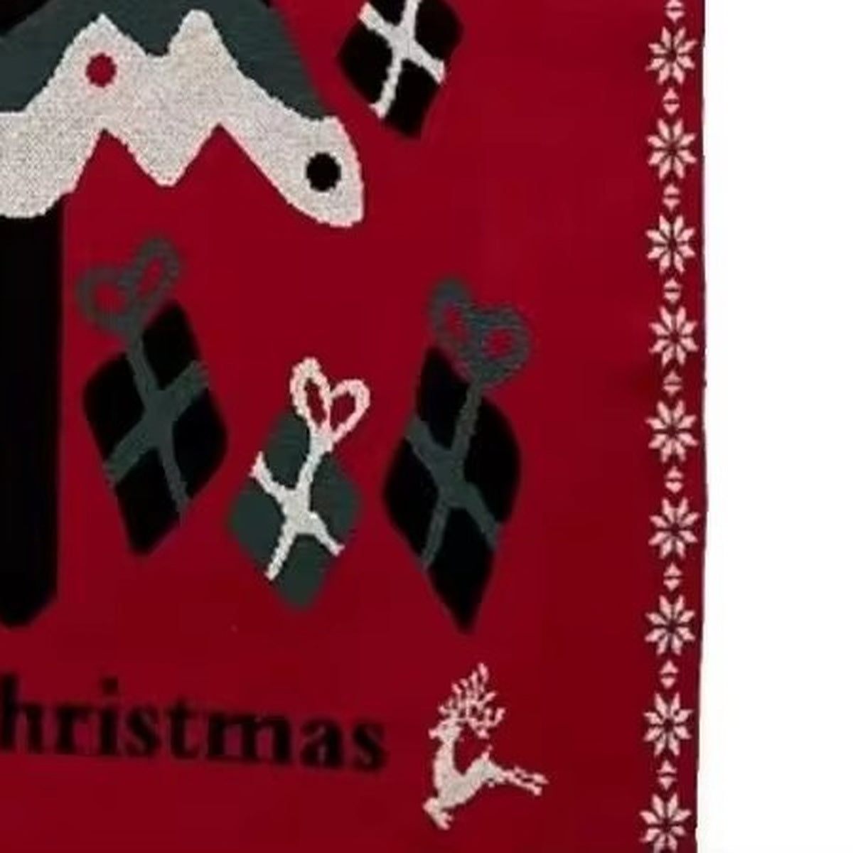 Close up of Velimoro christmas knit throw blanket showing red fabric, gifts, a reindeer and a snowflake border.