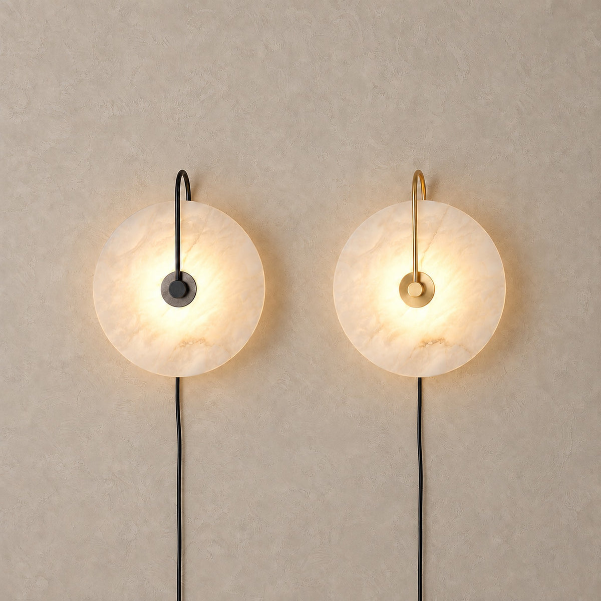 Velirsa black and gold wall lamps glowing side by side, showing both finishes