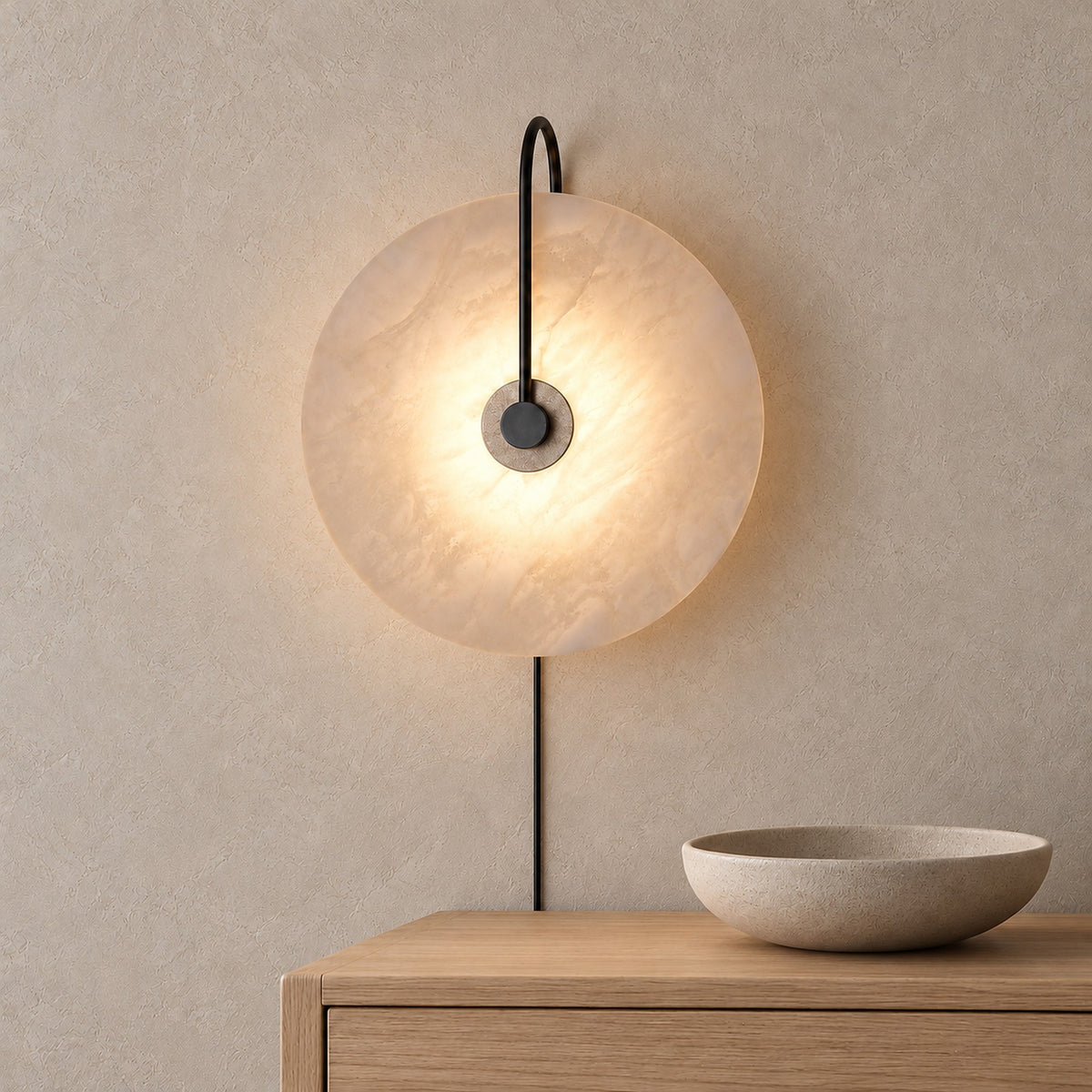 Velirsa black plug in wall light glowing above a dining sideboard in daylight