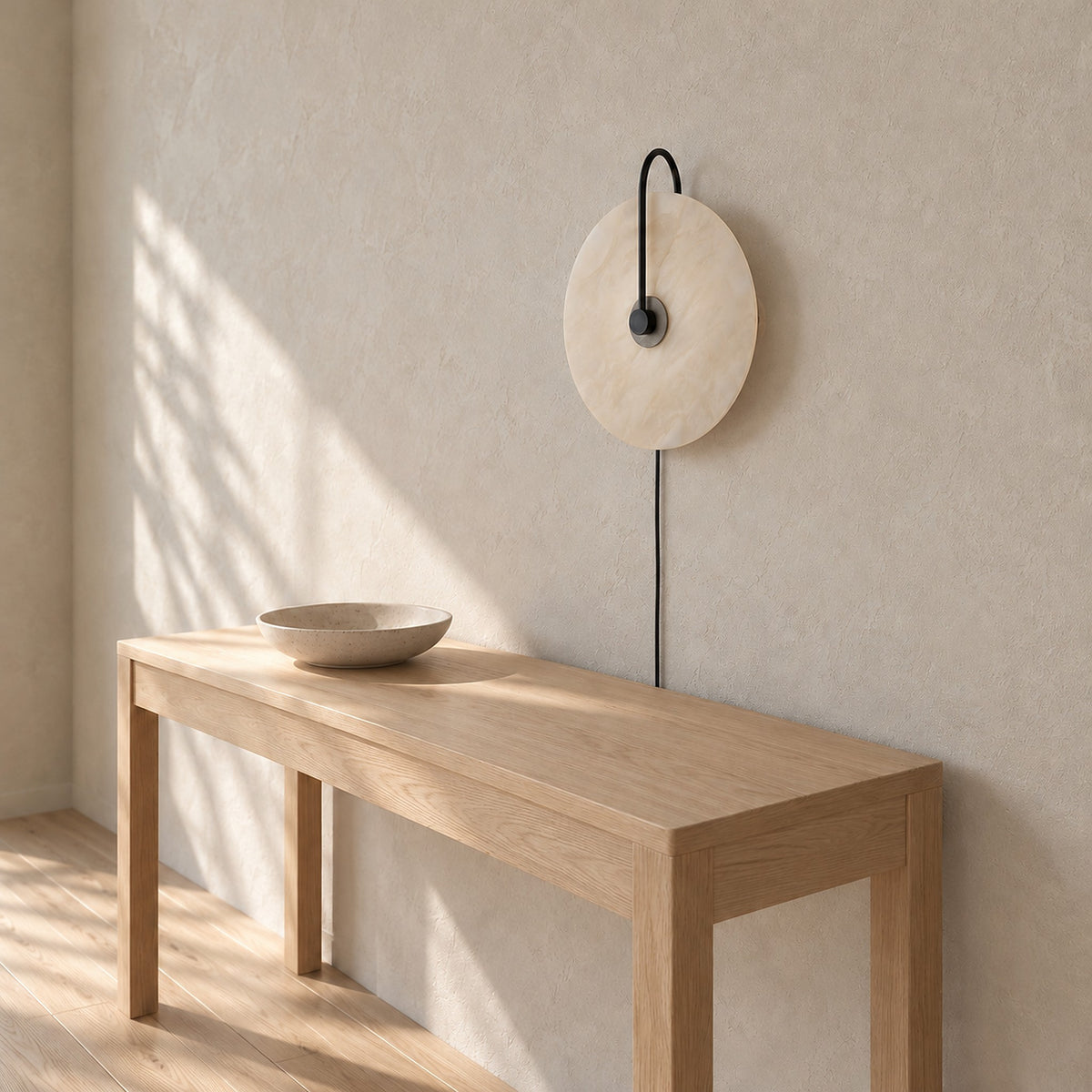 Velirsa black wall lamp unlit above a sunlit entryway console table