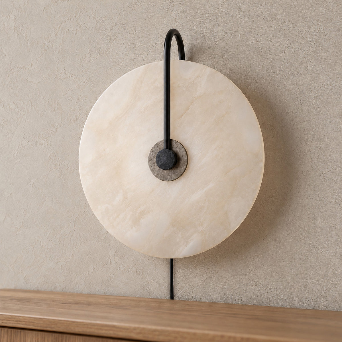 Velirsa black led wall sconce close up showing metal detailing and pale veining in the shade