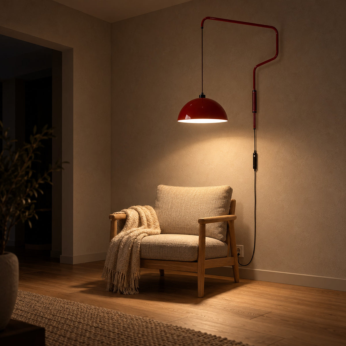 Velisano dark red bedside wall light glowing above a living room chair with its cord running down