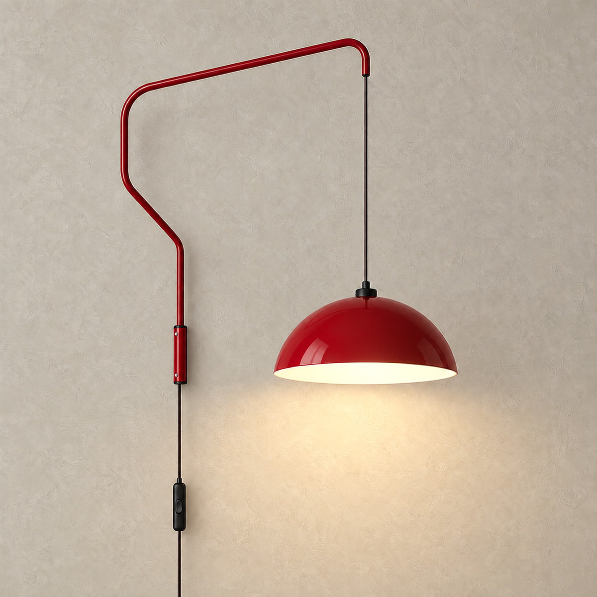 Velisano dark red wall light glowing against greige plaster with its dome shade lit