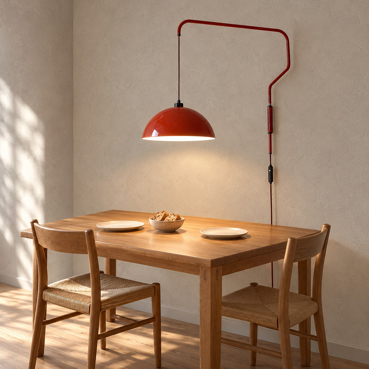 Velisano dark red wall light suspended over a kitchen corner table, keeping the tabletop clear