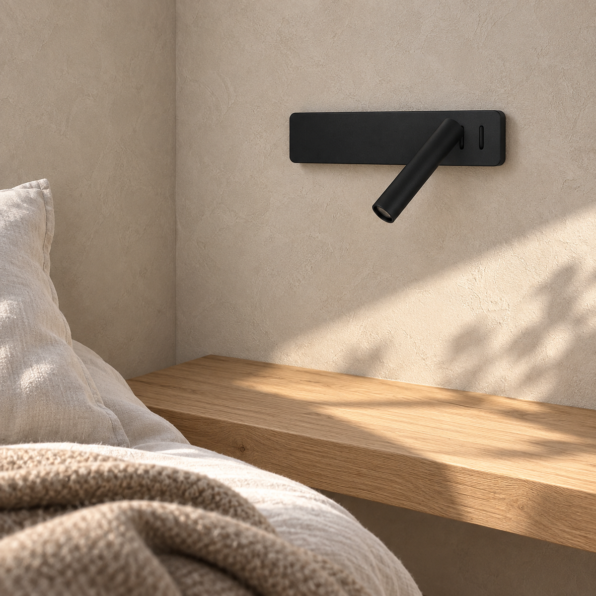Vemirsa black bedside lamp switched off on the wall above a clear tabletop in daylight