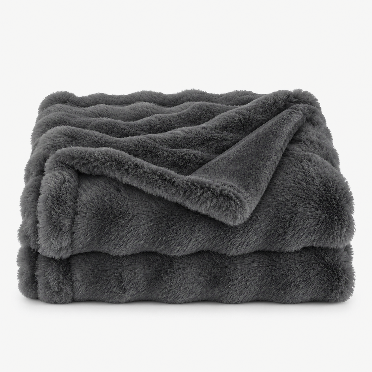 Vemorila dark gray faux fur blanket loosely folded on a plain white background