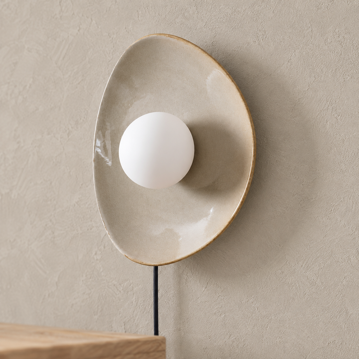Venalti taupe LED wall sconce close up on the glass globe and glazed ceramic rim