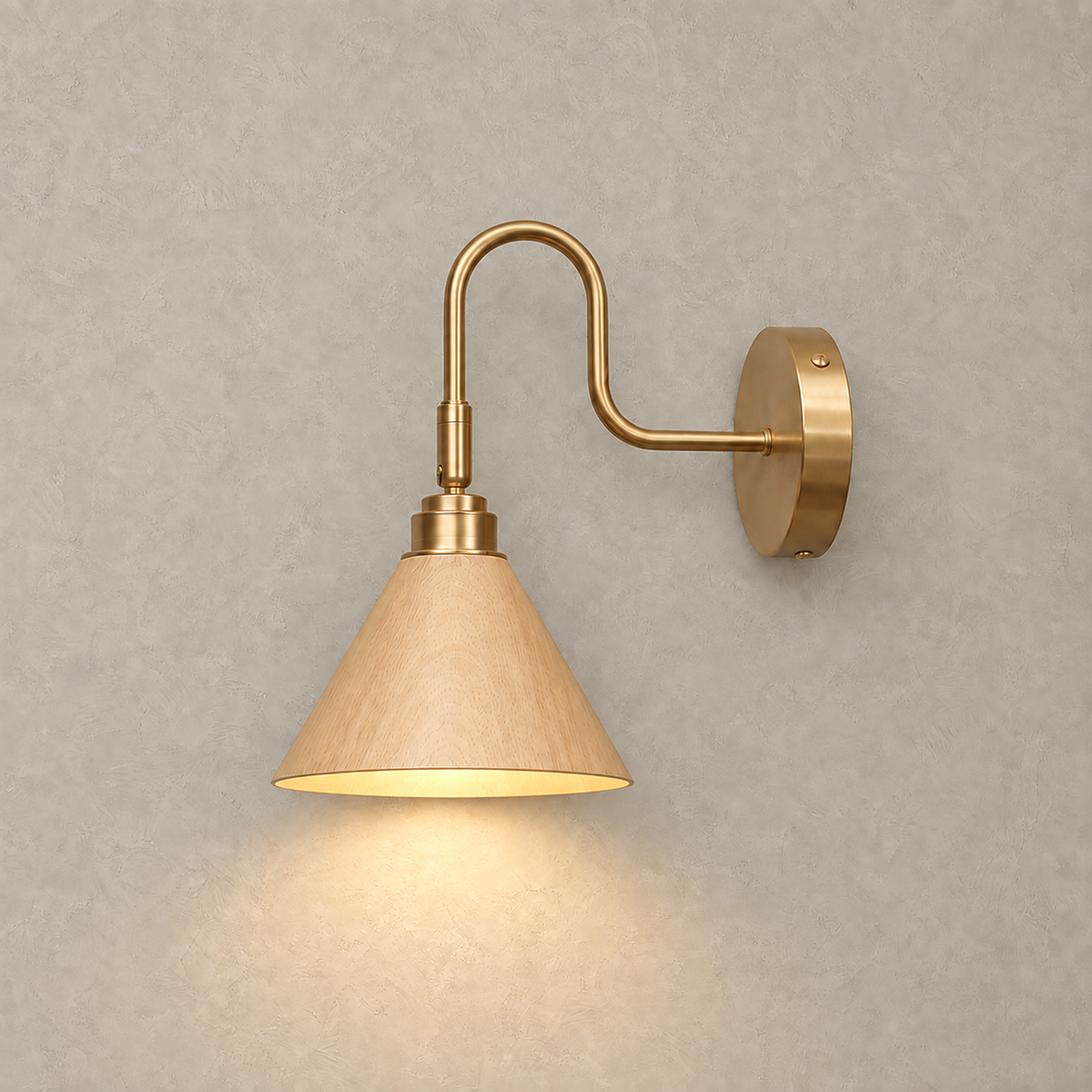 Vesomira wood and gold canopy wall sconce casting warm light below the cone shade