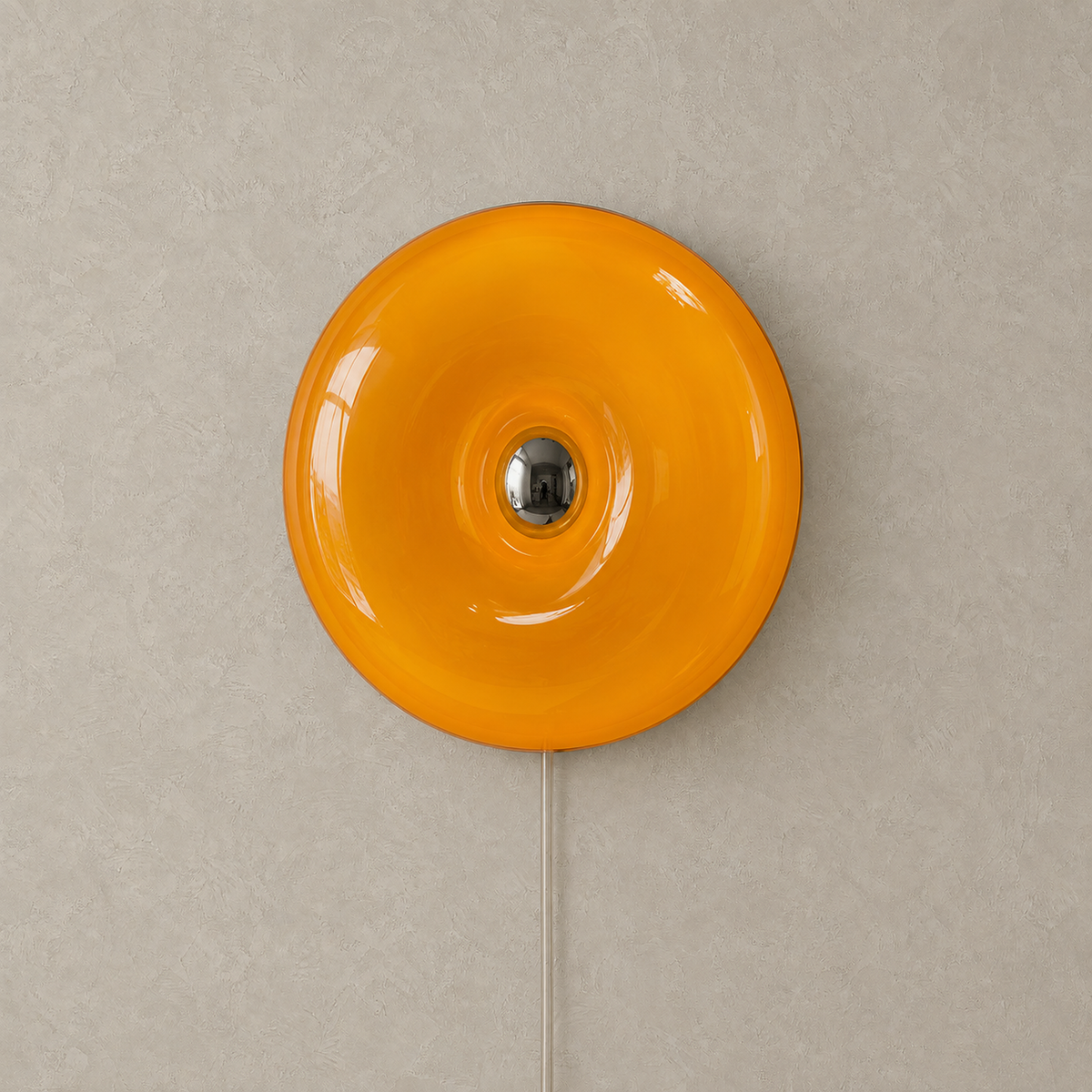 Vilomer orange plug in wall lamp, unlit glass ring mounted on greige plaster wall