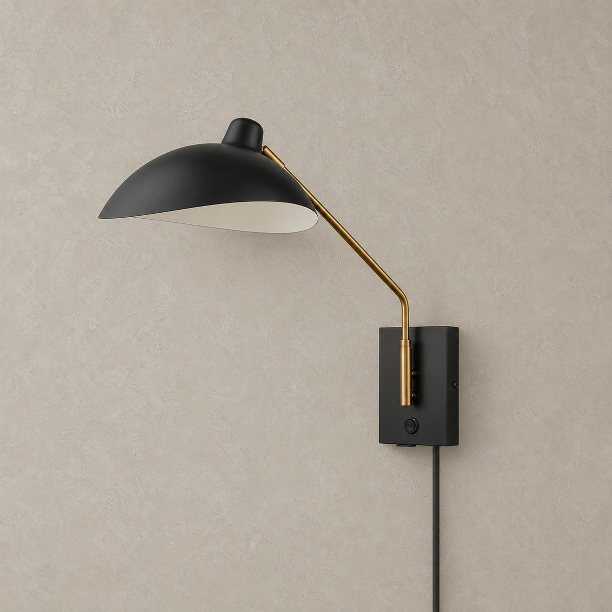 Vimolen black plug in wall sconce with brass colored arm and dome shade, light switched off